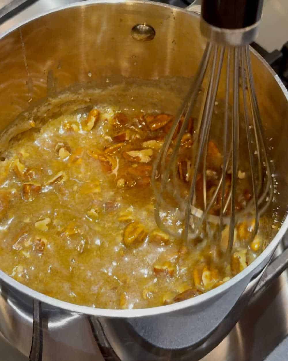 whisk caramel and pecans on stove.