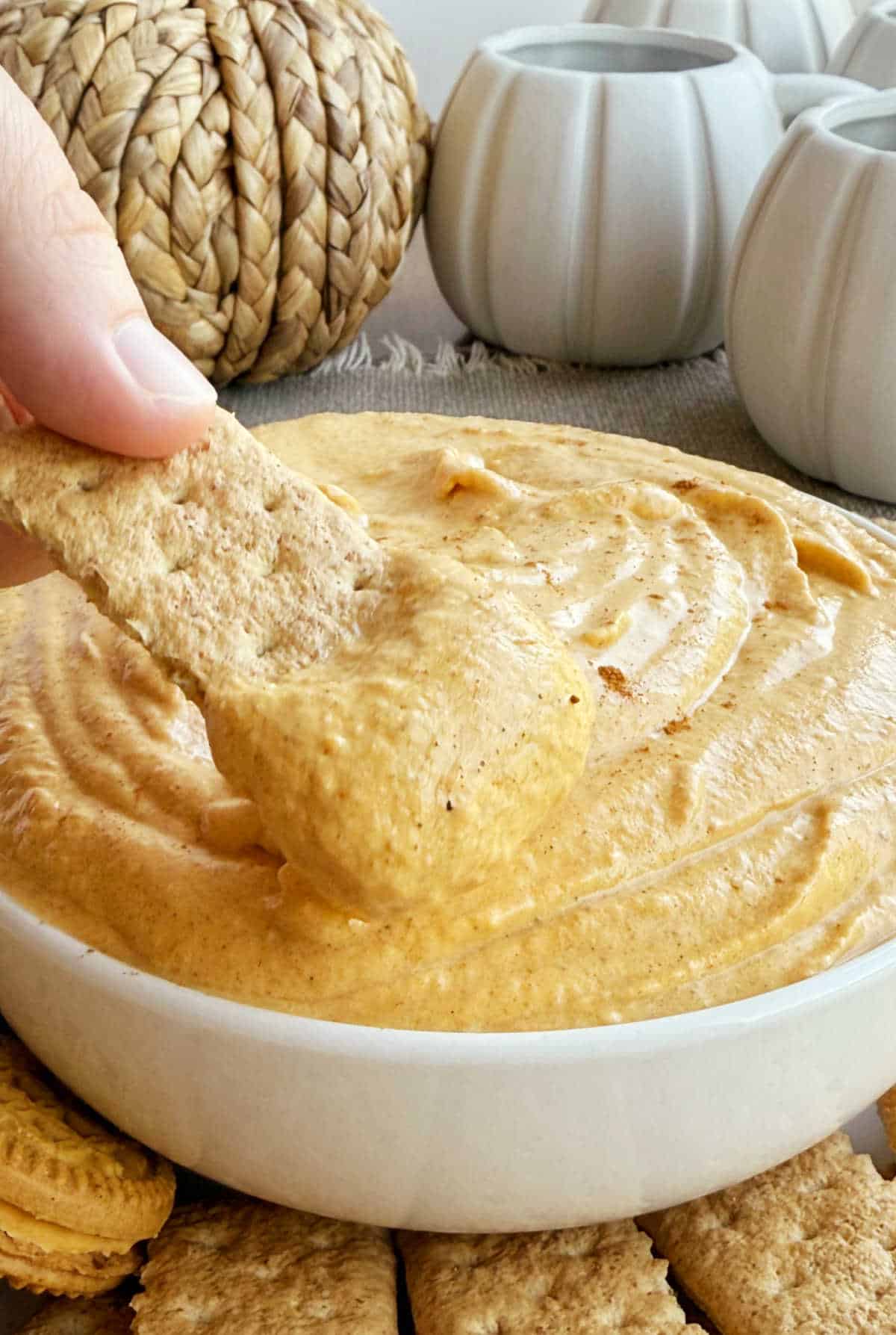 pumpkin cheesecake dip on graham cracker.