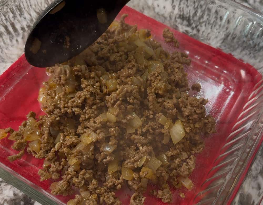 spread taco meat in baking dish.