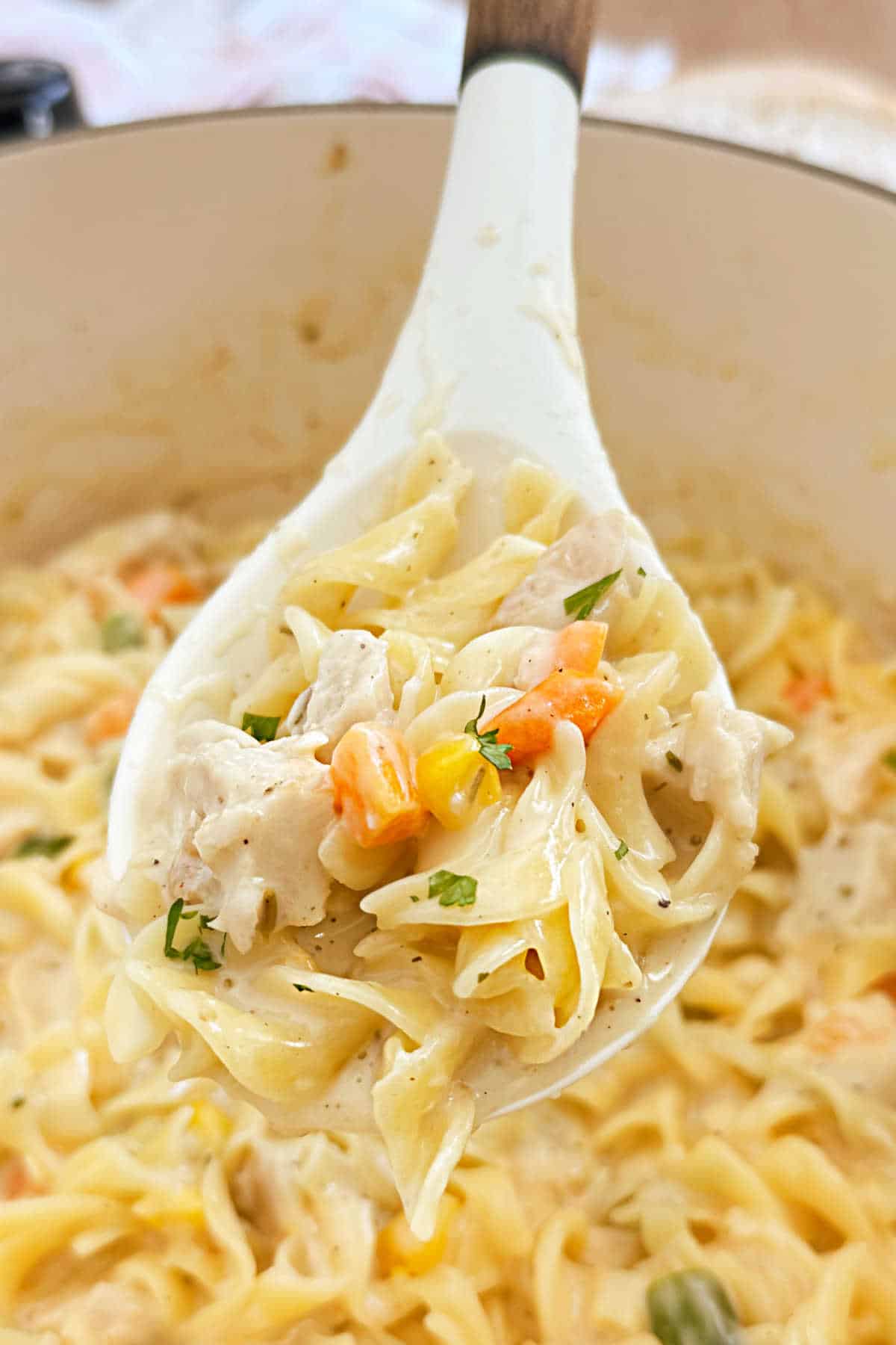 turkey noodle casserole on serving spoon.