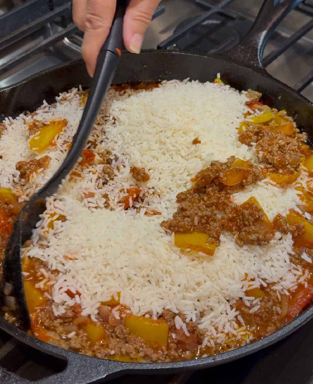 stir rice in skillet.