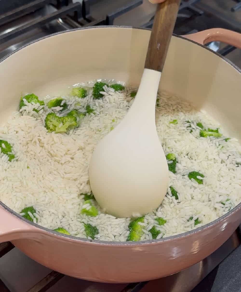 stir rice and broccoli on stove.