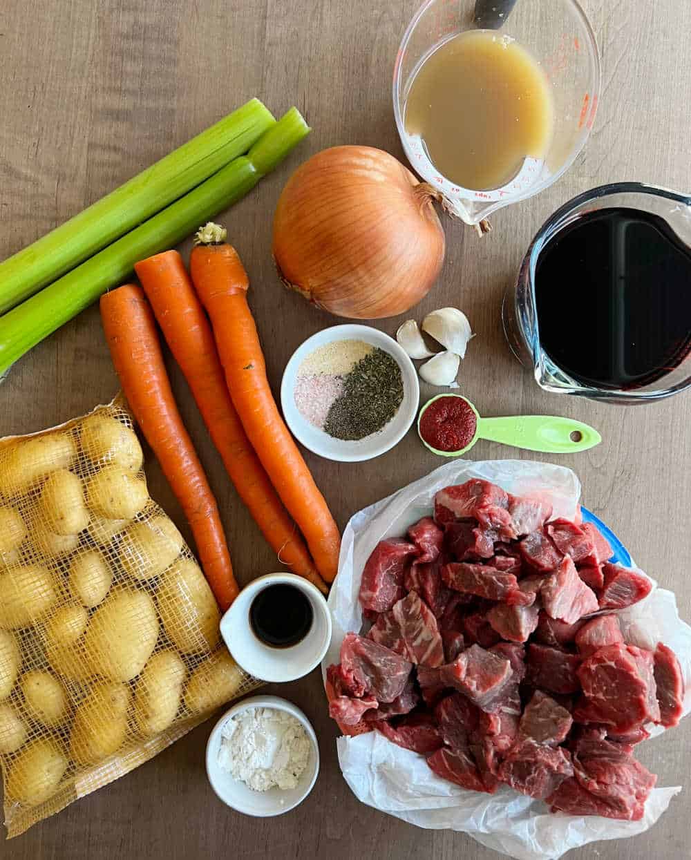 beef, carrots and potatoes and ingredients to make beef stew