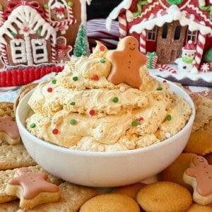 bowl of gingerbread dip with gingerbread man on top.