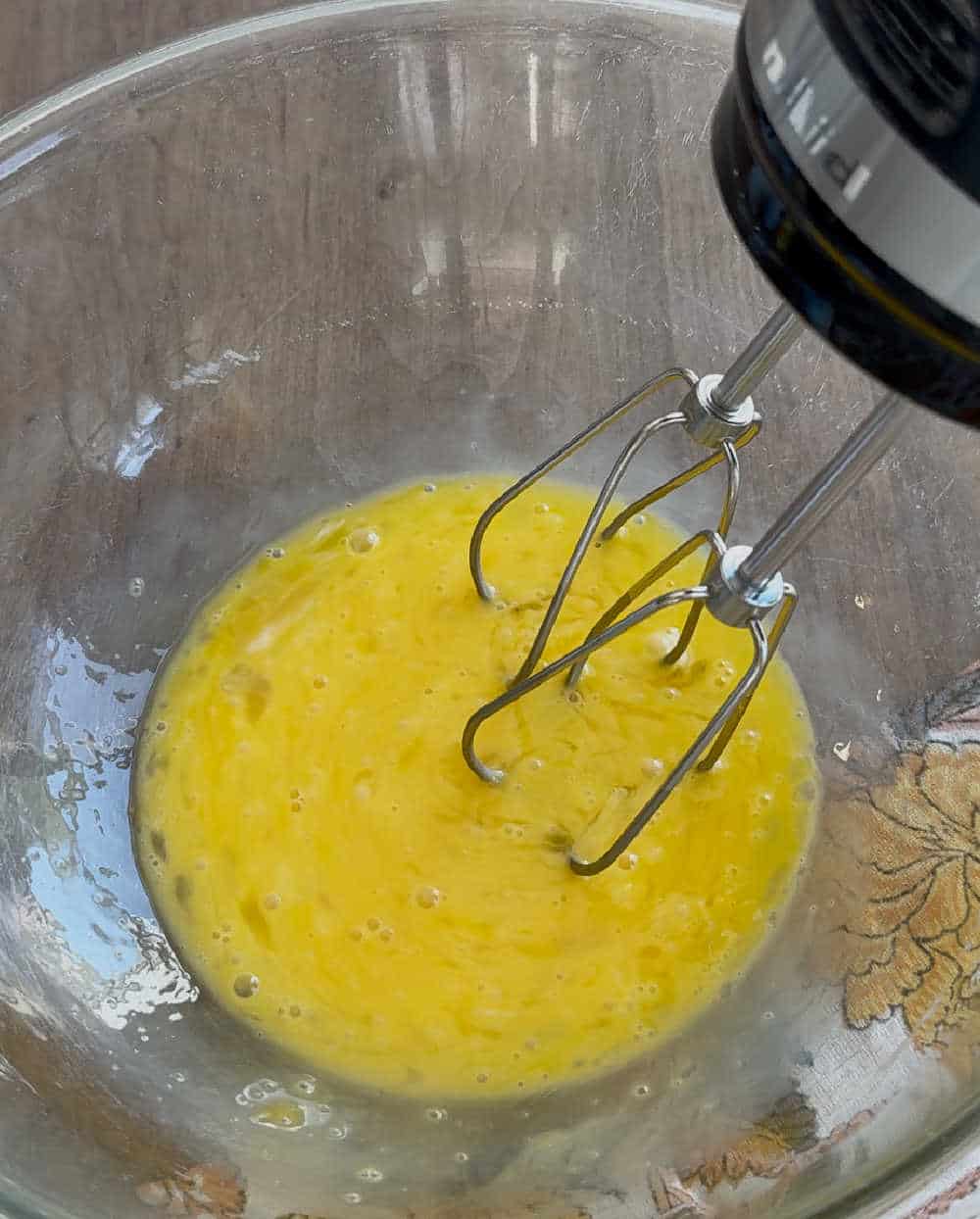 eggs in mixing bowl with mixer.