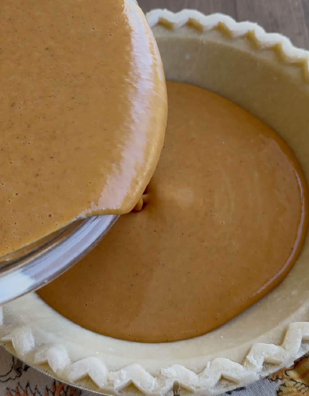 pour pie filling into pie crust.