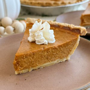 slice of homemade pumpkin pie on a plate.