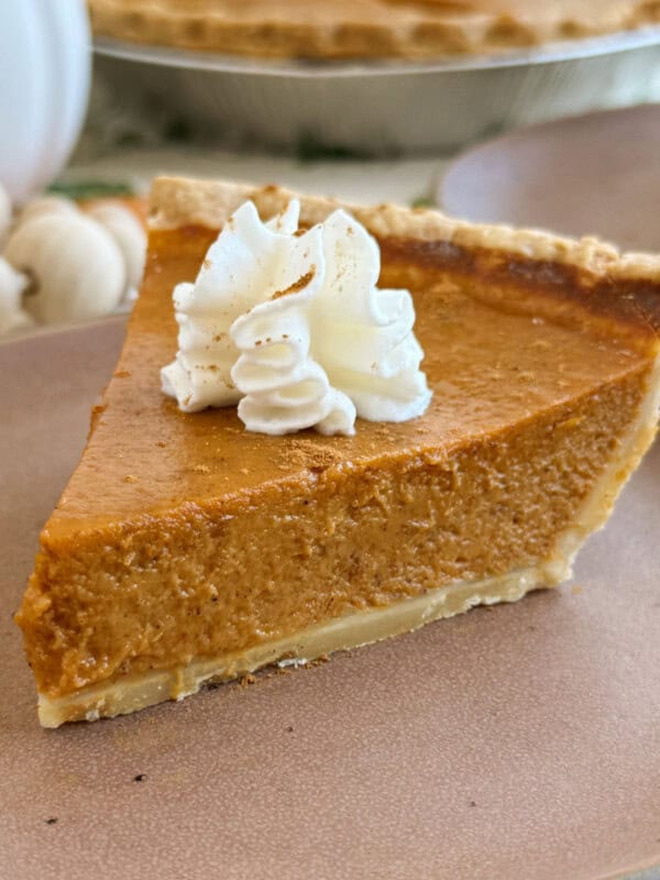 slice of homemade pumpkin pie on a plate.