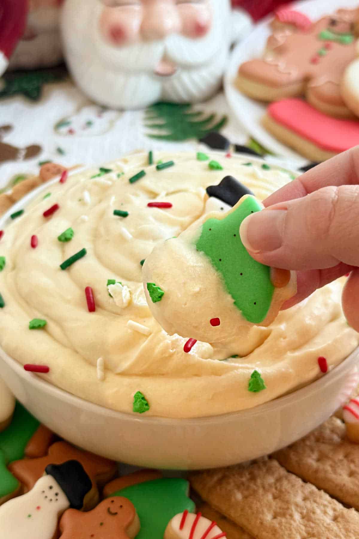 dipping sugar cookies into dip.