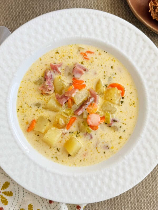 ham and potato soup in a white bowl.