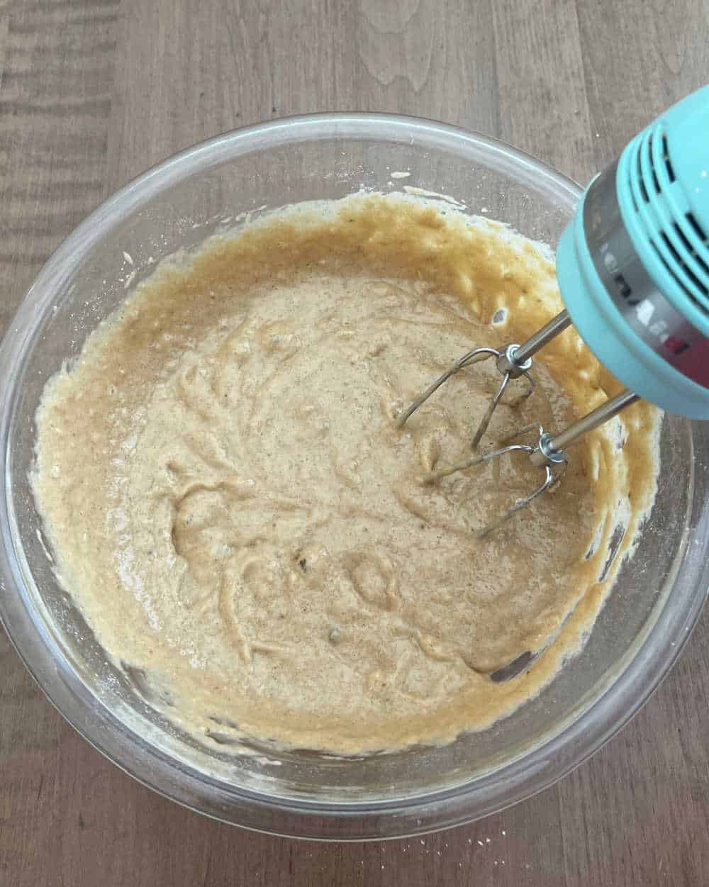 mix muffin batter with hand mixer.