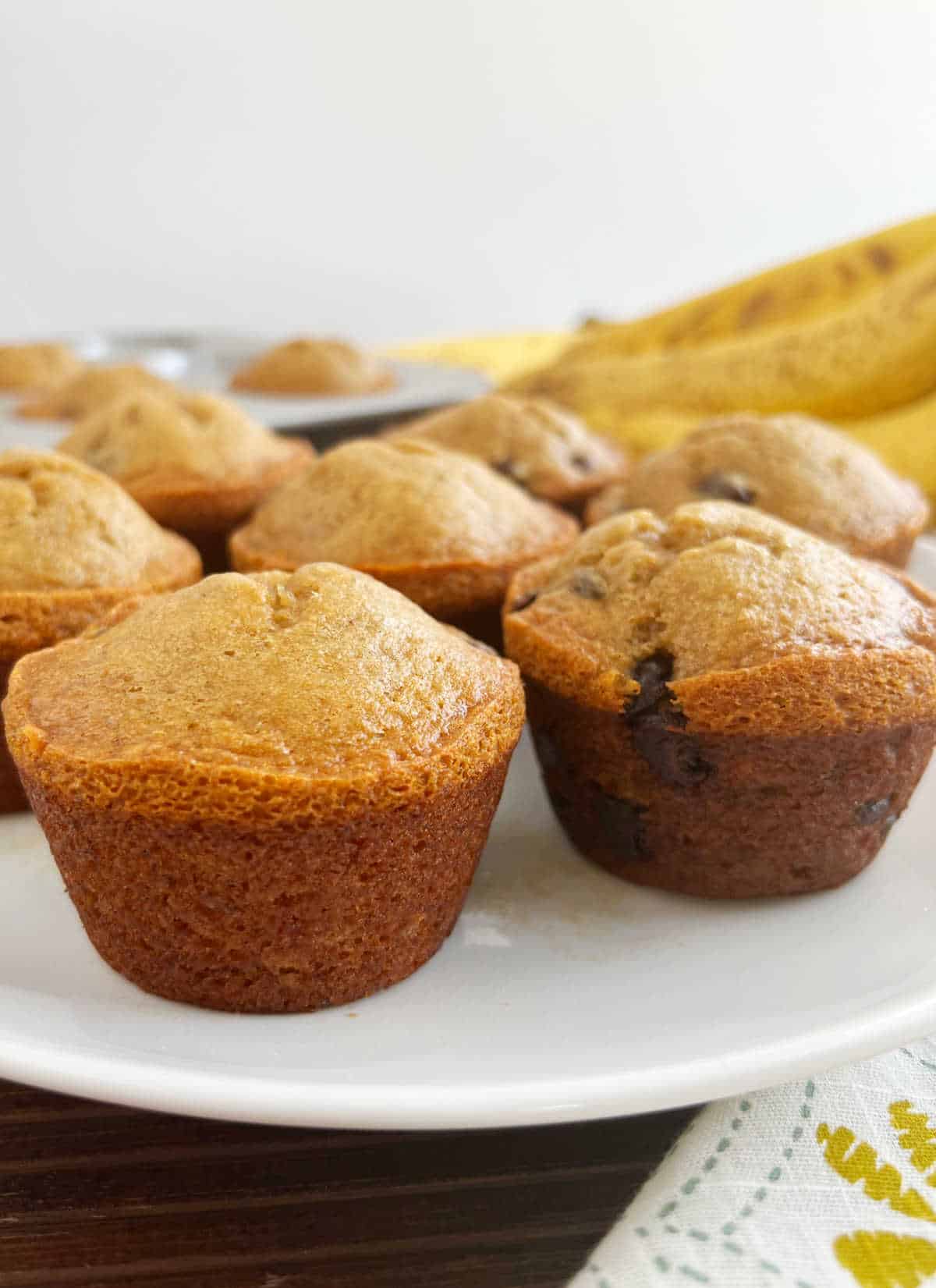 banana muffins with applesauce and chocolate chips on the table.