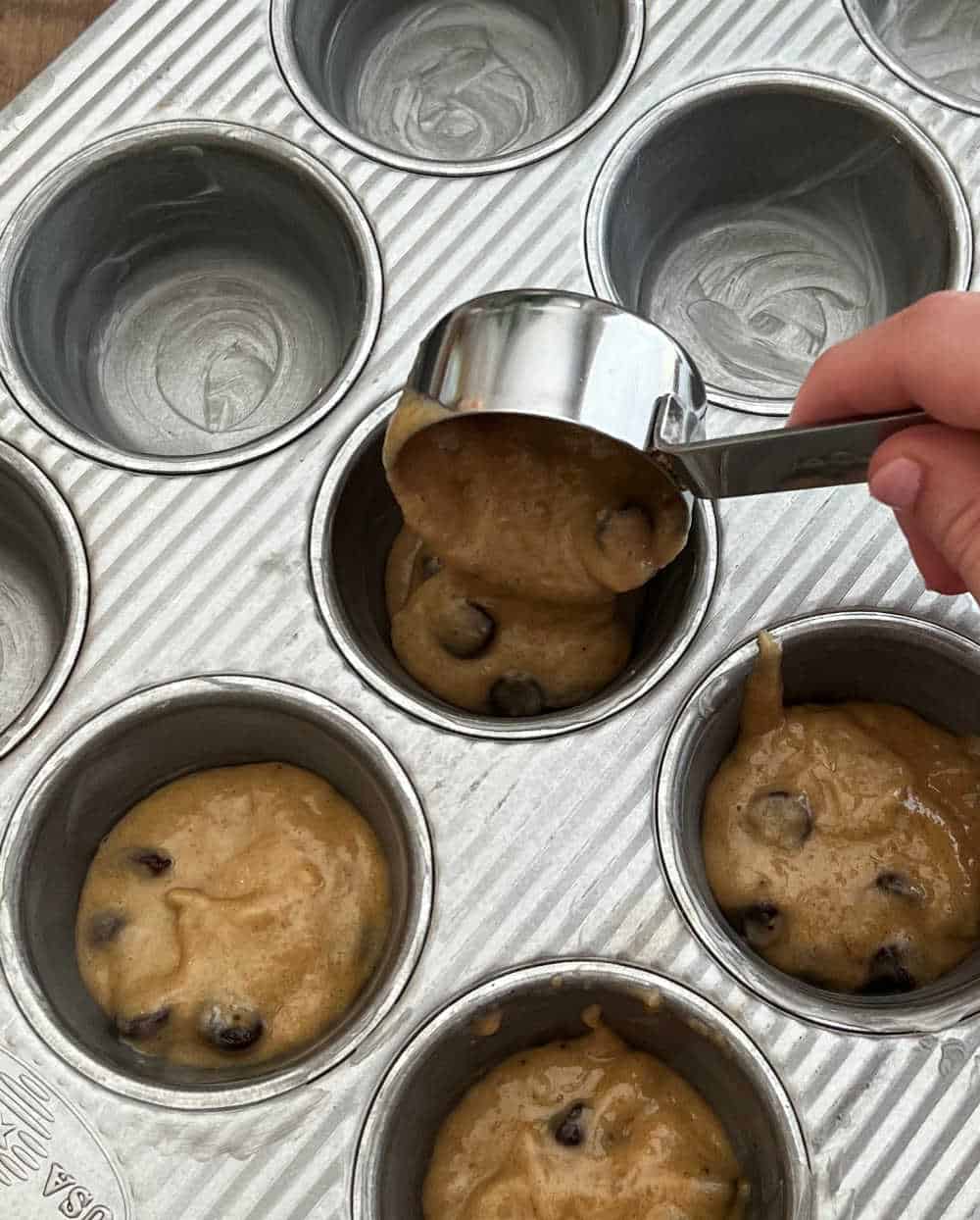 scoop muffin batter into muffin pan.