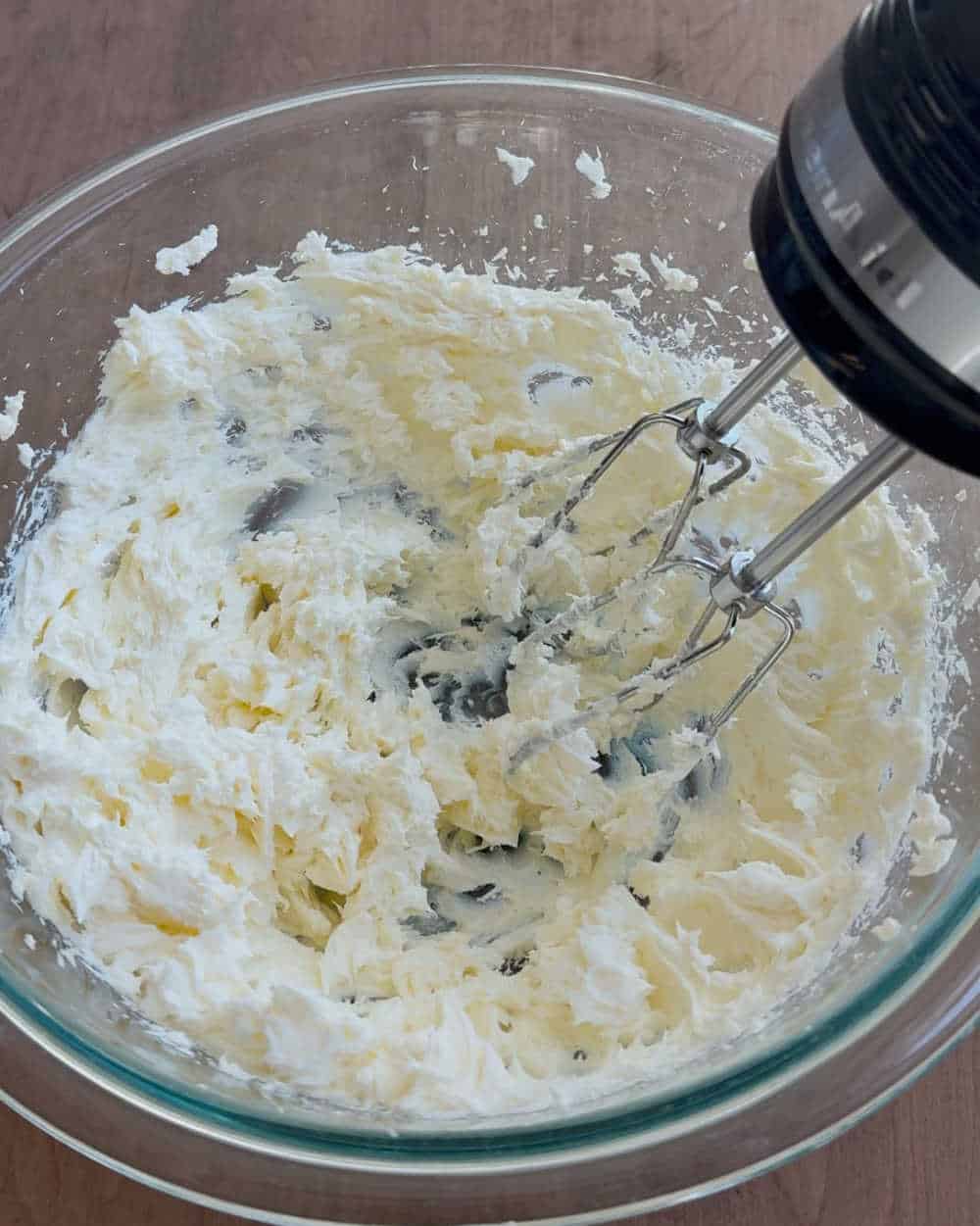 cream cheese in mixing bowl with electric mixer.