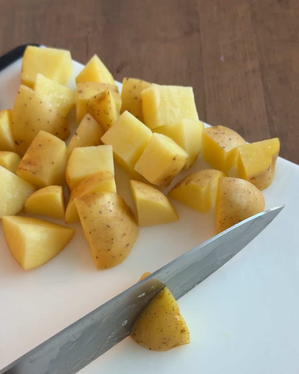 cut potatoes on cutting board.