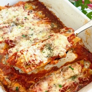 beef and cheese manicotti on a serving spoon.