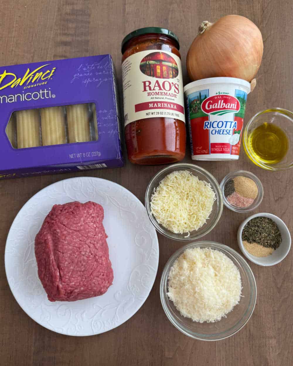 ground beef, manicotti shells and cheese and ingredients to make it.