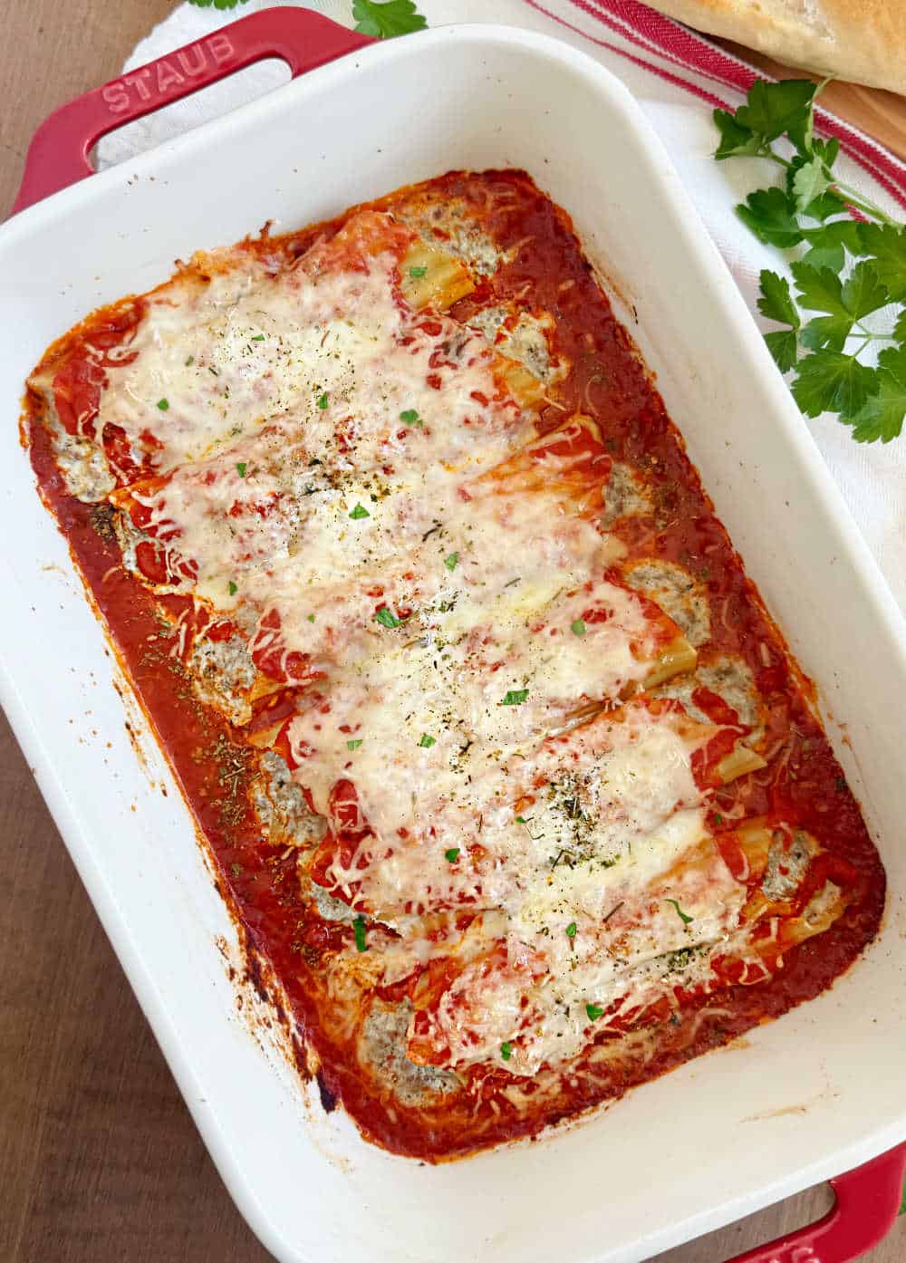 manicotti with meat and cheese in baking dish.