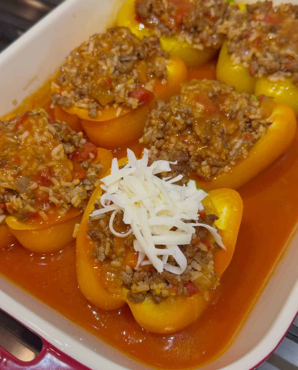 top peppers with shredded cheese.