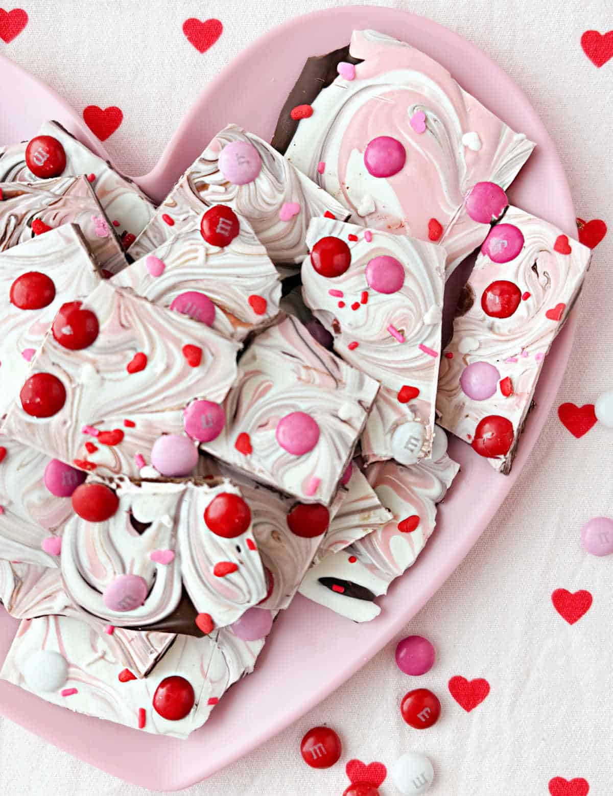 Valentine candy bark on pink heart plate.