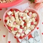 valentine's day puppy chow with valentine m&m candy in bowl.