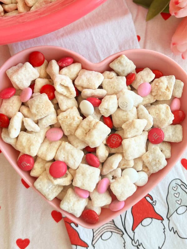 valentine's day puppy chow with valentine m&m candy in bowl.