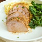 slices of baked pork tenderloin on a plate.