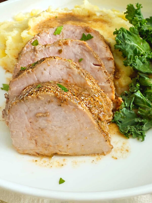 slices of baked pork tenderloin on a plate.