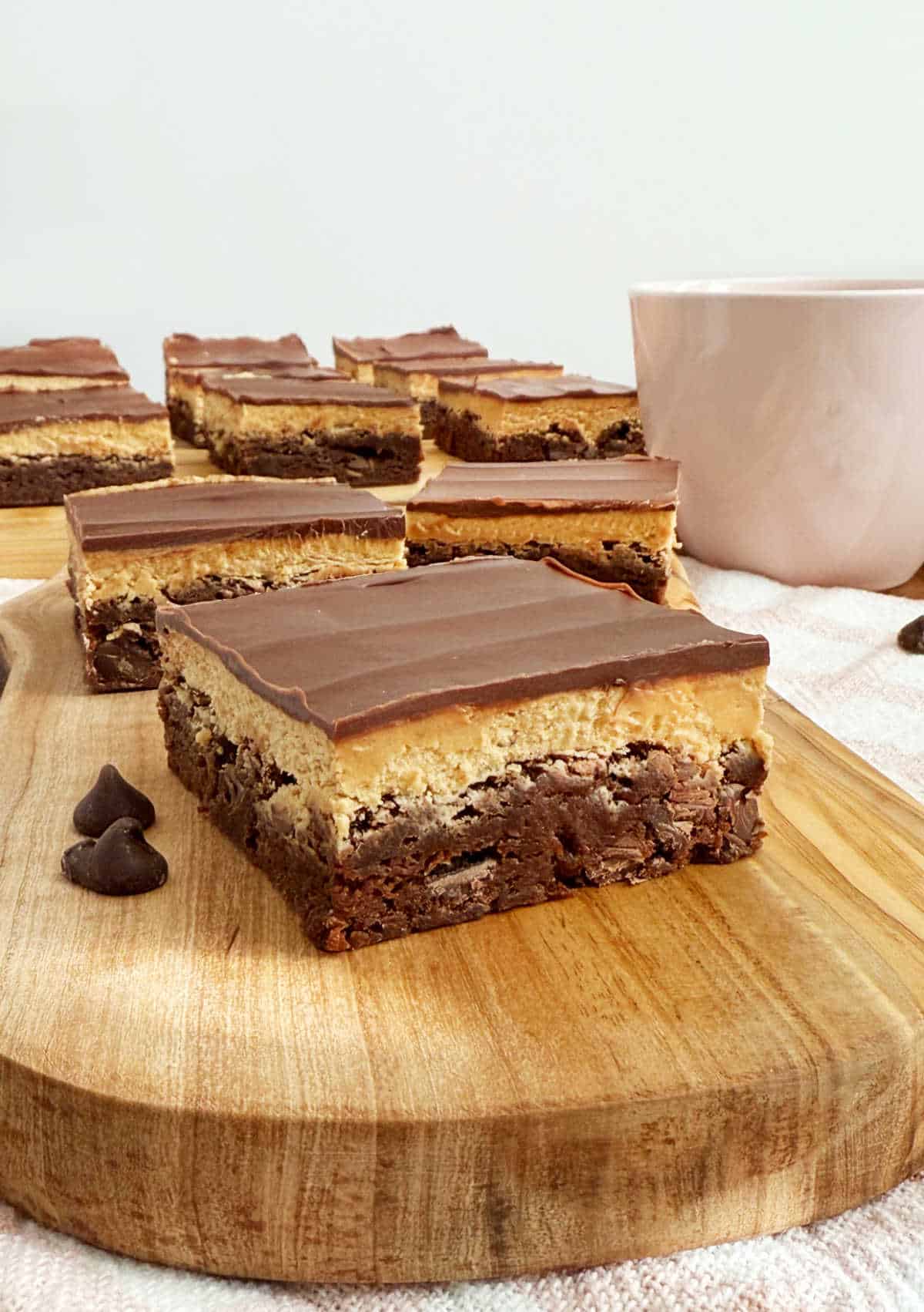 coffee brownie with coffee buttercream and ganache on cutting board.