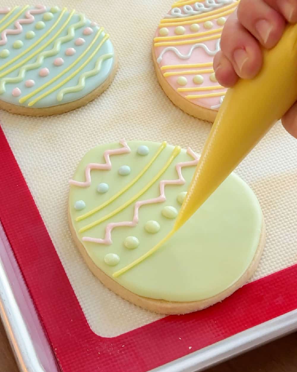 decorate Easter egg cookies with icing.